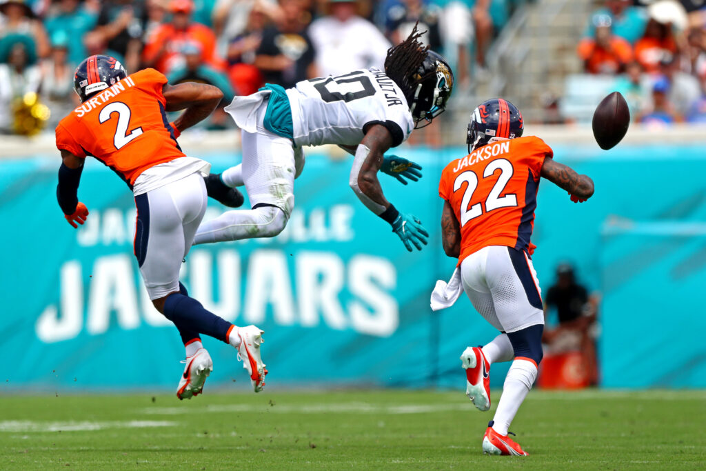 Denver Broncos cornerback Pat Surtain II (2) and strong safety Kareem Jackson (22) break up a pass intended for Jacksonville Jaguars wide receiver Laviska Shenault Jr. (10) during the second quarter at TIAA Bank Field.