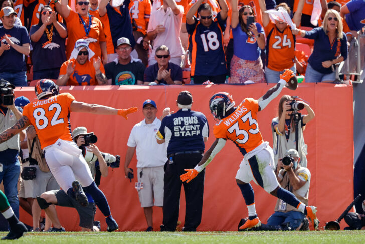 Denver Broncos running back Javonte Williams (33) celebrates after his touchdown in the first quarter against the New York Jets at Empower Field at Mile High.