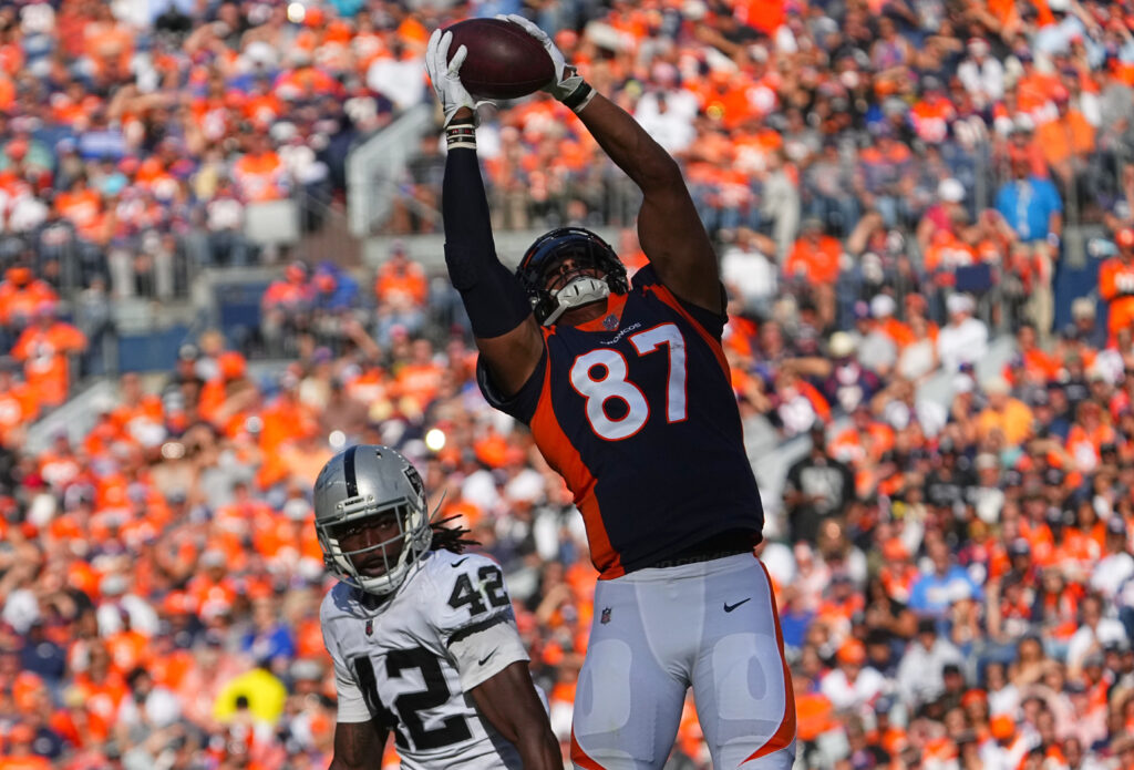 Denver Broncos tight end Noah Fant (87) pulls in a reception past Las Vegas Raiders inside linebacker Cory Littleton (42) in the first half at Empower Field at Mile High.