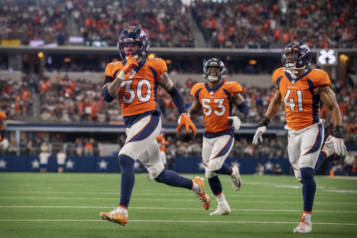 Denver Broncos safety Caden Sterns (30) motions to the Dallas Cowboys fans after he intercepts a pass during the second half at AT&T Stadium.