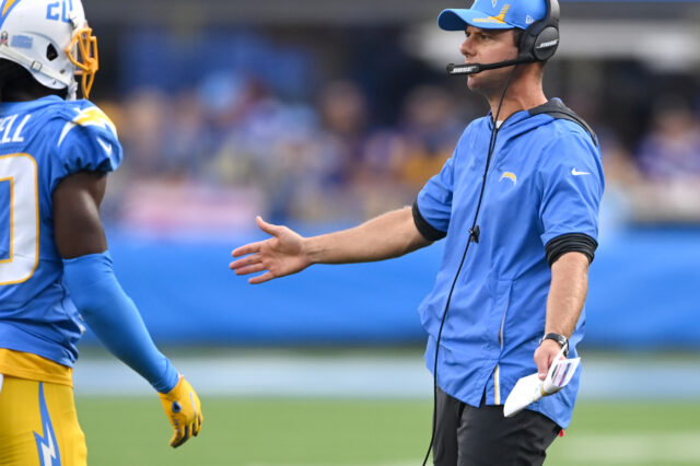 Los Angeles Chargers head coach Brandon Staley shakes hands with players as they come off the field during in the first half against against the Minnesota Vikings at SoFi Stadium.