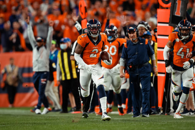 Denver Broncos cornerback Pat Surtain II (2) runs the ball back for a touchdown on an interception in the fourth quarter against the Los Angeles Chargers at Empower Field at Mile High.