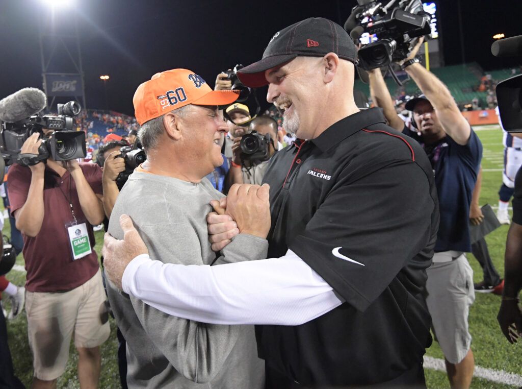 Denver Broncos head coach Vic Fangio and Atlanta Falcons head coach Dan Quinn shake hands after the Pro Football Hall of Fame Game at Tom Benson Hall of Fame Stadium. The Broncos defeated the Falcons 14-10.