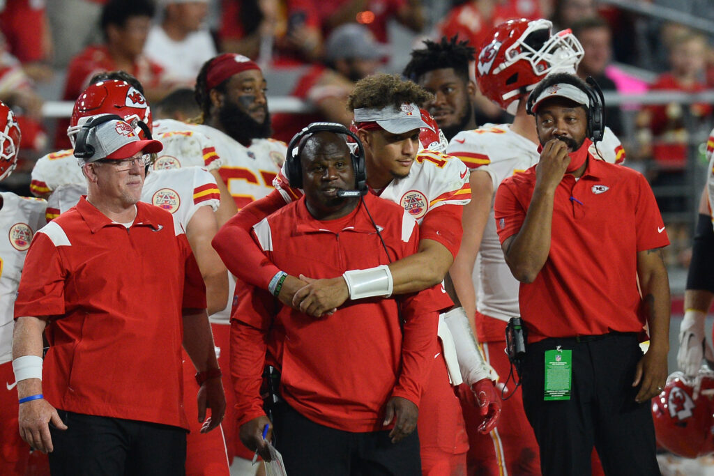 Kansas City Chiefs quarterback Patrick Mahomes (15) hugs offensive coordinator Eric Bieniemy (formerly of the Colorado Buffaloes) during the second half of the game against the Arizona Cardinals at State Farm Stadium.