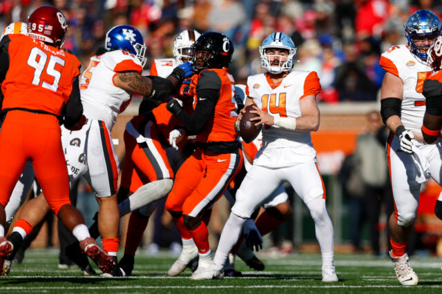 American squad quarterback Sam Howell of North Carolina (14) drops back to pass in the first half against the National squad at Hancock Whitney Stadium.