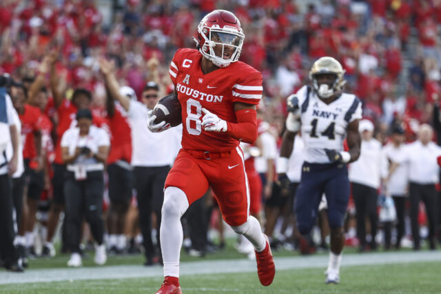 Houston Cougars cornerback Marcus Jones (8) returns a punt for a touchdown during the first quarter against the Navy Midshipmen at TDECU Stadium.