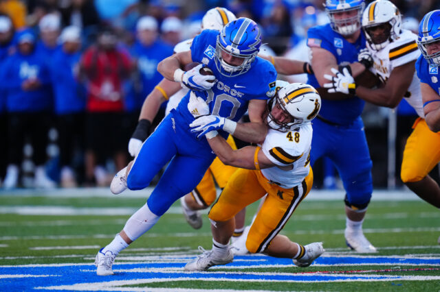 Wyoming Cowboys linebacker Chad Muma (48) tackles Air Force Falcons running back Brad Roberts (20) in the first quarter at Falcon Stadium.