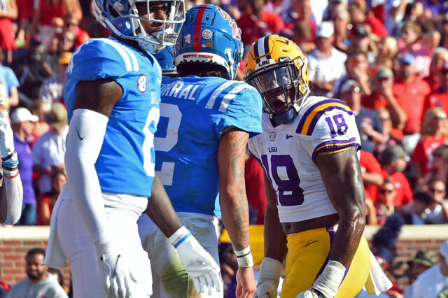 LSU Tigers linebacker Damone Clark (18) reacts against Mississippi Rebels quarterback Matt Corral (2) during the first half at Vaught-Hemingway Stadium.