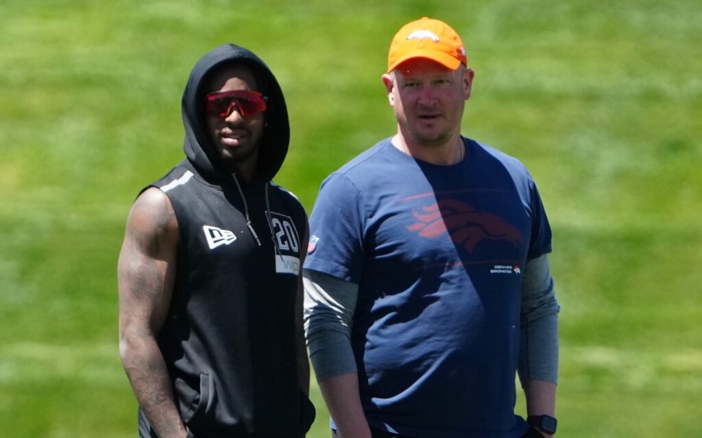 Nathaniel Hackett and KJ Hamler watch rookie minicamp on Friday. Credit: Ron Chenoy, USA TODAY Sports.