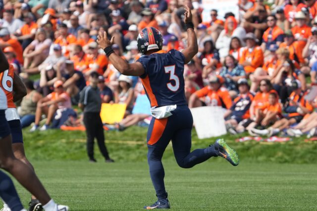 Russell Wilson lighting it up at Broncos training camp. Credit: Ron Chenoy, USA TODAY Sports.