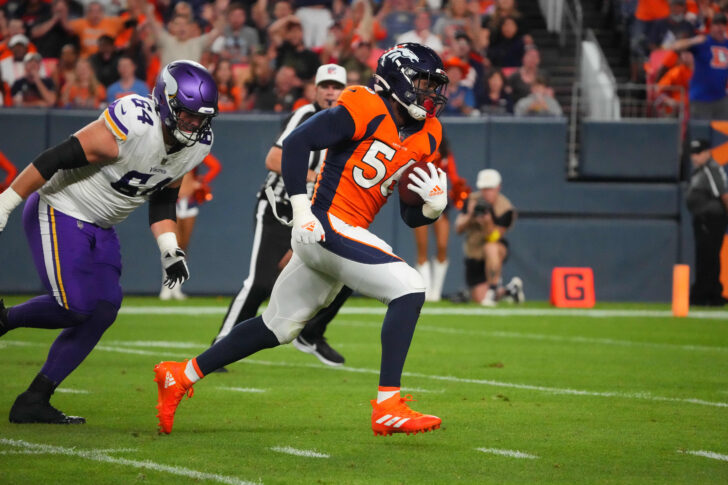 Denver Broncos linebacker Baron Browning (56) picks up a fumble and runs for a touchdown with Minnesota Vikings offensive tackle Blake Brandel (64) giving chase in the second quarter at Empower Field at Mile High.