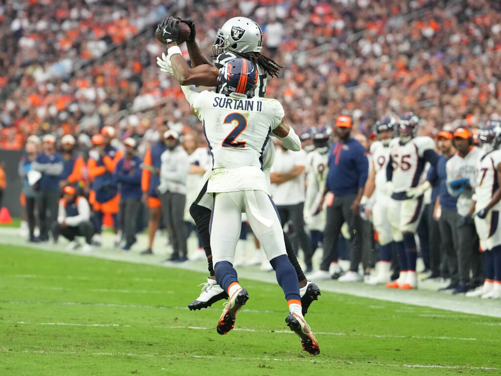 Las Vegas Raiders (AFC West) wide receiver Davante Adams (17) makes a catch against Denver Broncos cornerback Pat Surtain II (2) during a game at Allegiant Stadium.