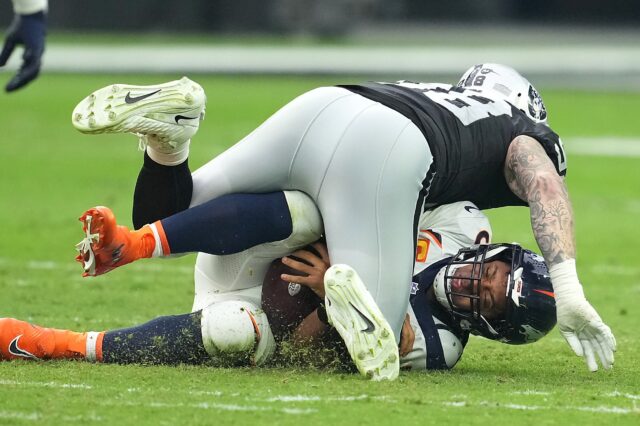 Maxx Crosby lands on Russell Wilson in Week 4. Credit: Stephen L. Sylvanie, USA TODAY Sports.