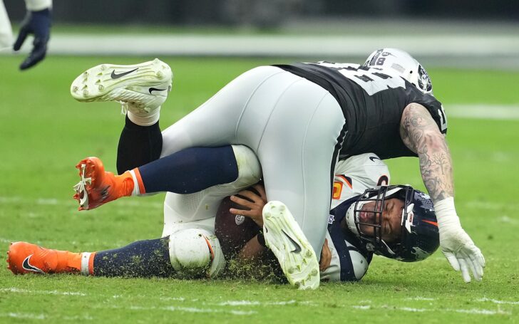 Maxx Crosby lands on Russell Wilson in Week 4. Credit: Stephen L. Sylvanie, USA TODAY Sports.