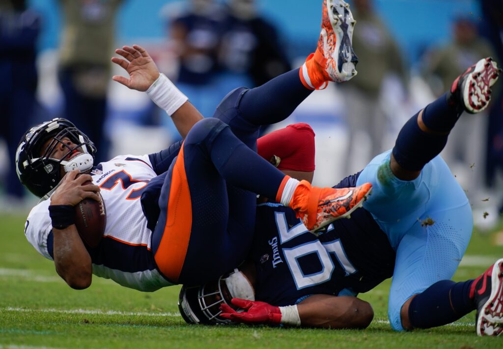 Tennessee Titans defensive end DeMarcus Walker (95) sacks Denver Broncos quarterback Russell Wilson (3) during the third quarter at Nissan Stadium Sunday, Nov. 13, 2022, in Nashville, Tenn.