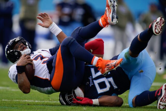 Tennessee Titans defensive end DeMarcus Walker (95) sacks Denver Broncos quarterback Russell Wilson (3) during the third quarter at Nissan Stadium Sunday, Nov. 13, 2022, in Nashville, Tenn.