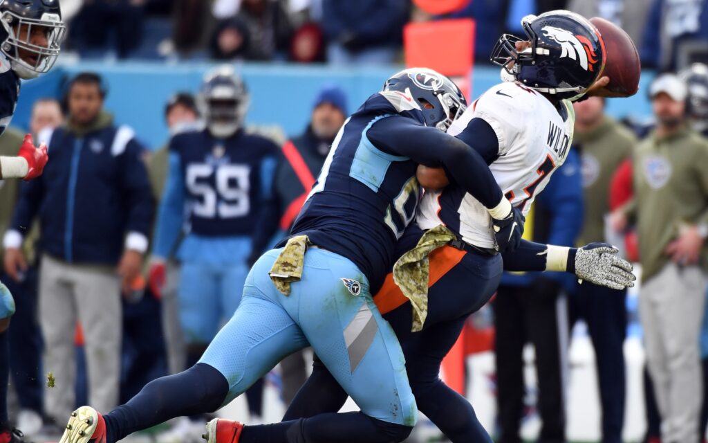 Russell Wilson hit as he throws against the Titans. Credit: Chris Hanewinckel, USA TODAY Sports.