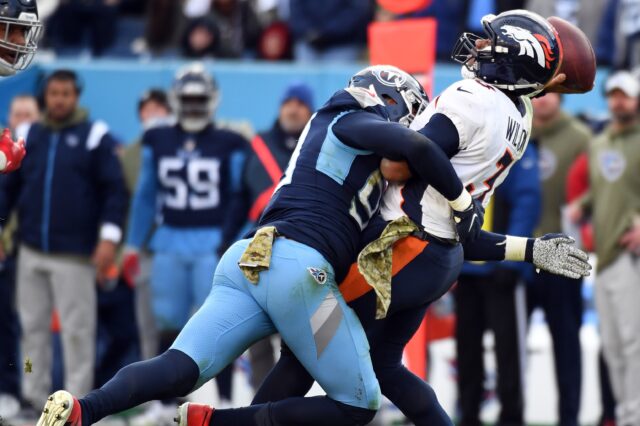 Russell Wilson hit as he throws against the Titans. Credit: Chris Hanewinckel, USA TODAY Sports.