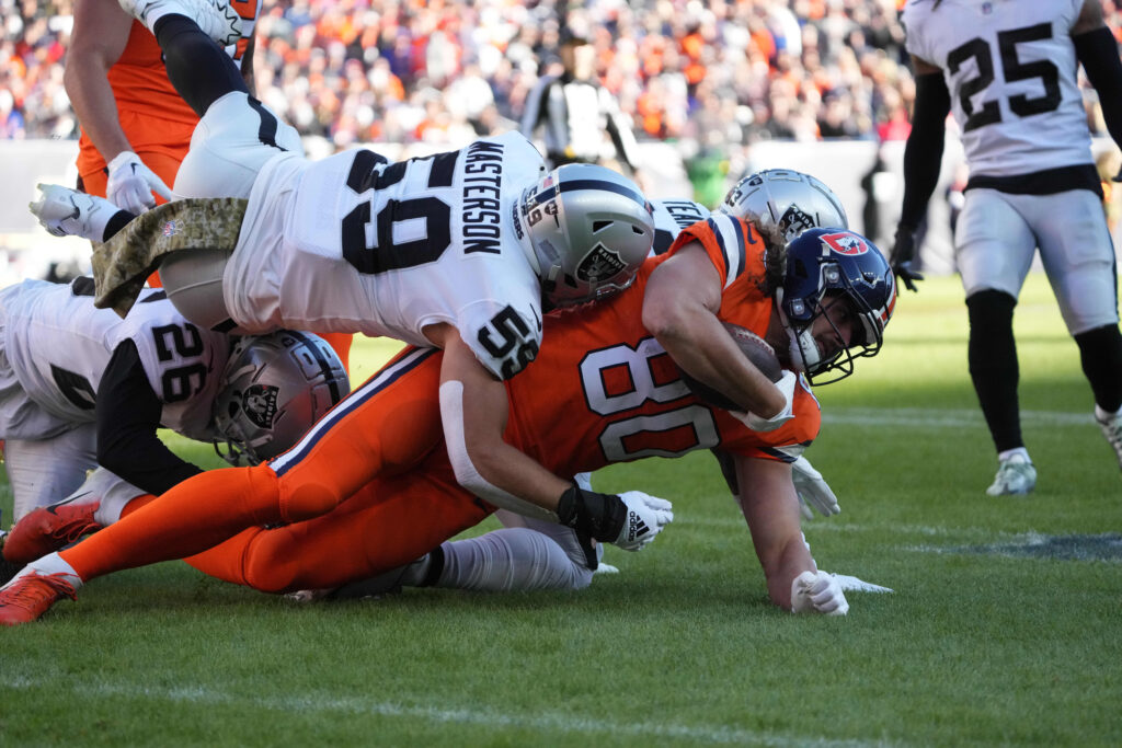 Las Vegas Raiders linebacker Luke Masterson (59) tackles Denver Broncos tight end Greg Dulcich (80) in the first quarter at Empower Field at Mile High.