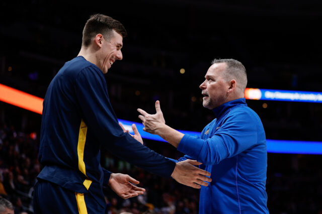 Denver Nuggets head coach Michael Malone talks with forward Vlatko Cancar