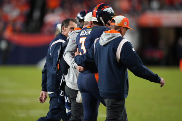 Denver Broncos quarterback Russell Wilson (3) is taken off the field by training staff in the fourth quarter against the Kansas City Chiefs at Empo