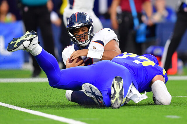 Denver Broncos quarterback Russell Wilson (3) is sacked by Los Angeles Rams defensive tackle Michael Hoecht (97) during the second half at SoFi Stadium.