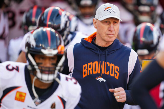 Denver Broncos interim head coach Jerry Rosburg and quarterback Russell Wilson (3) take the field prior to a game against the Kansas City Chiefs at GEHA Field at Arrowhead Stadium.