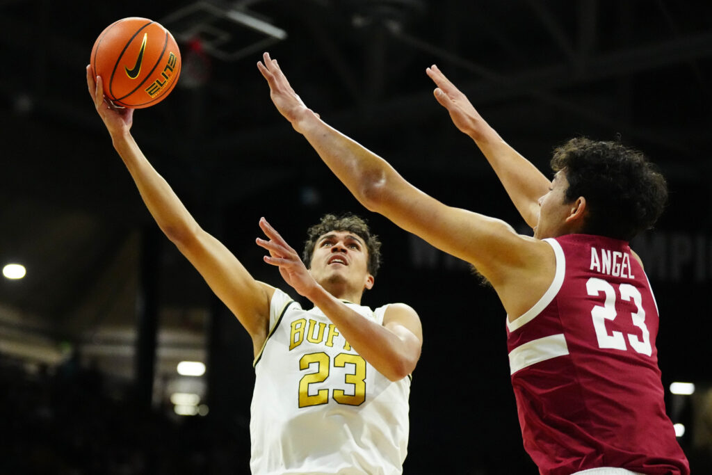 Colorado Buffaloes forward Tristan da Silva (23) shoots the ball over Stanford Cardinal forward Brandon Angel (23) in. the first half at the CU Events Center.