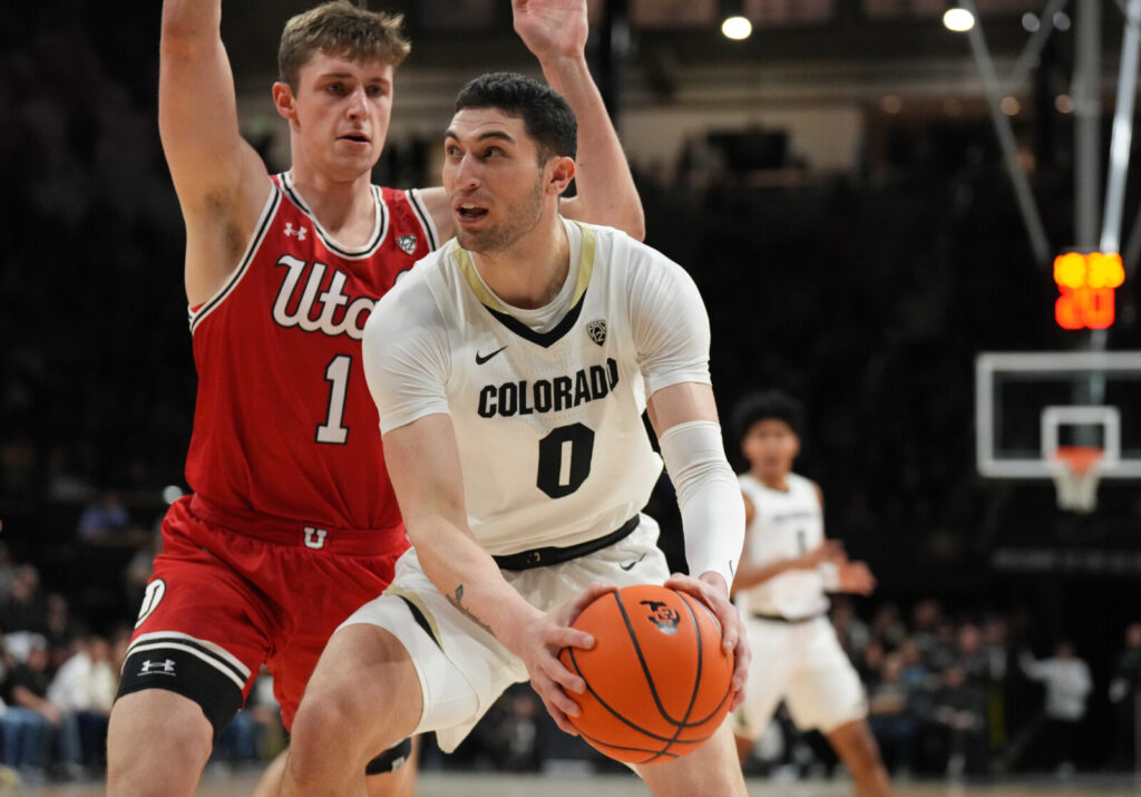 Utah Utes forward Ben Carlson (1) defends on Colorado Buffaloes guard Luke O'Brien (0) on the first half at the CU Events Center.