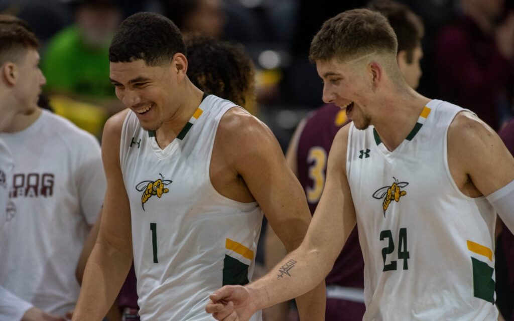 Joel Scott (1) celebrates with a Black Hills State teammate in March, 2023.