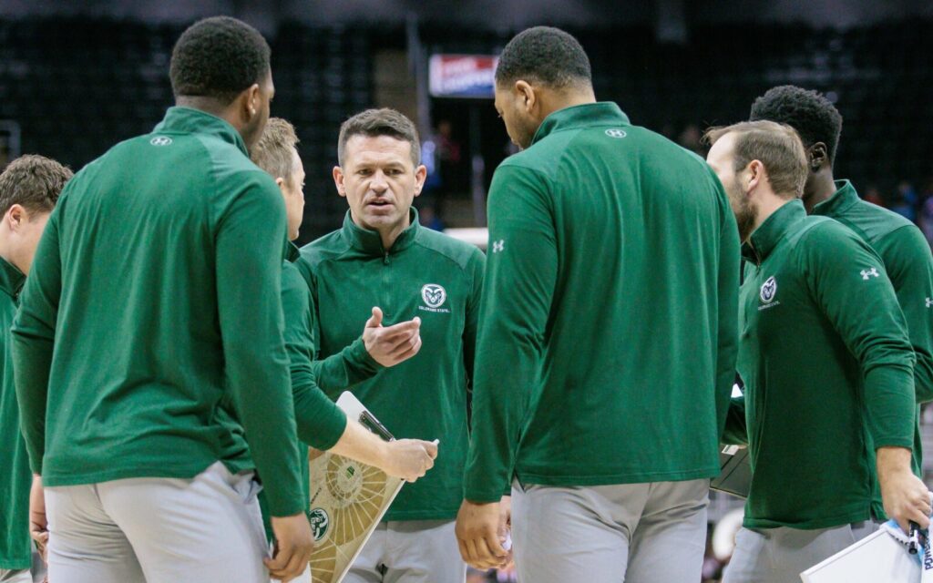 Niko Medved in the middle of his coaching staff at the Hall of Fame Classic.