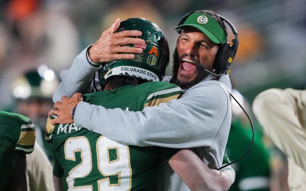 Rams head coach Jay Norvell hugs Justin Marshall