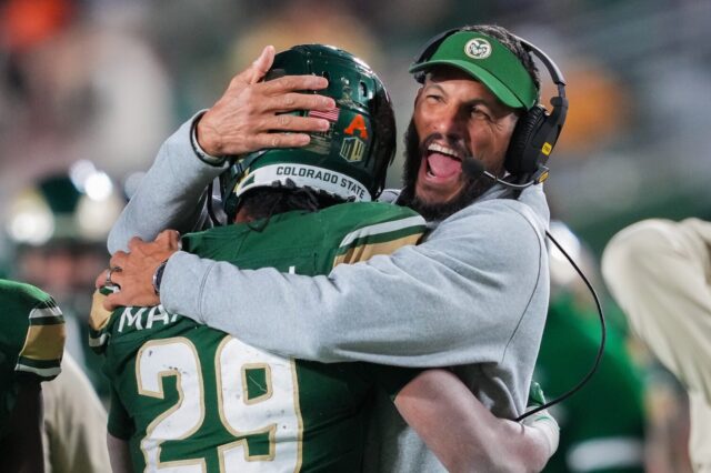 Rams head coach Jay Norvell hugs Justin Marshall