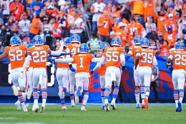 Denver Broncos celebrate a turnover in their throwback uniforms.