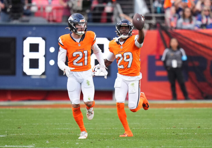 Denver Broncos cornerback Ja'Quan McMillian (29) celebrates his turnover with cornerback Riley Moss (21) in the second half against the Carolina Panthers at Empower Field at Mile High.