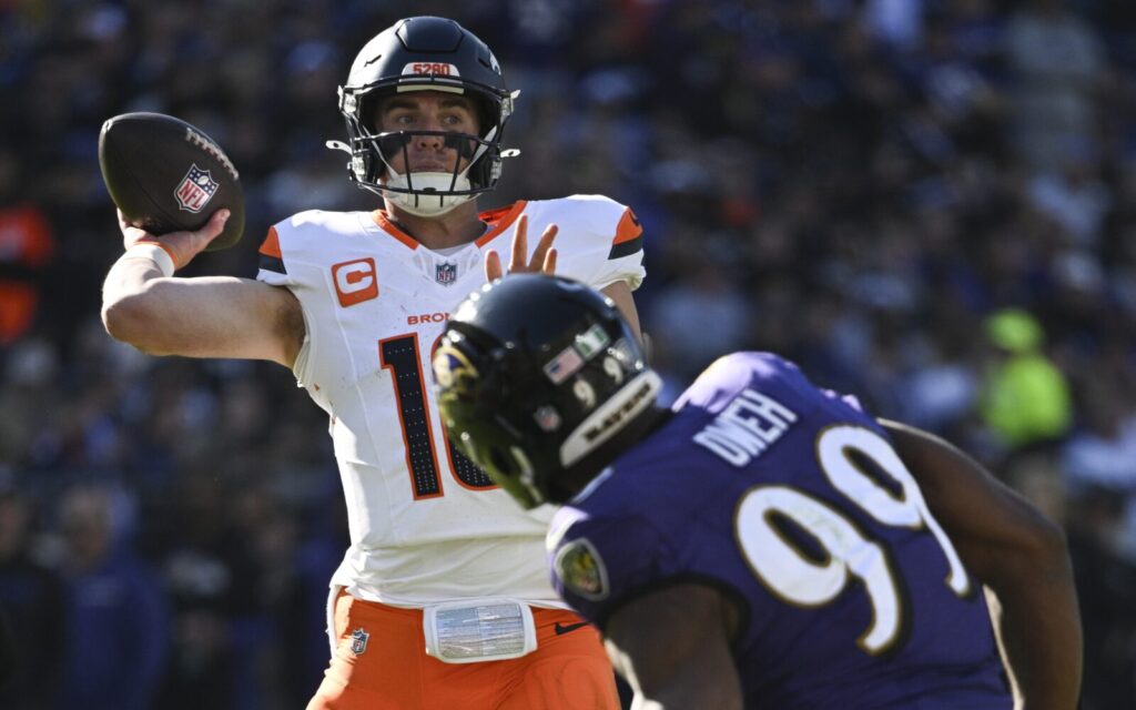 Bo Nix throws against Baltimore.