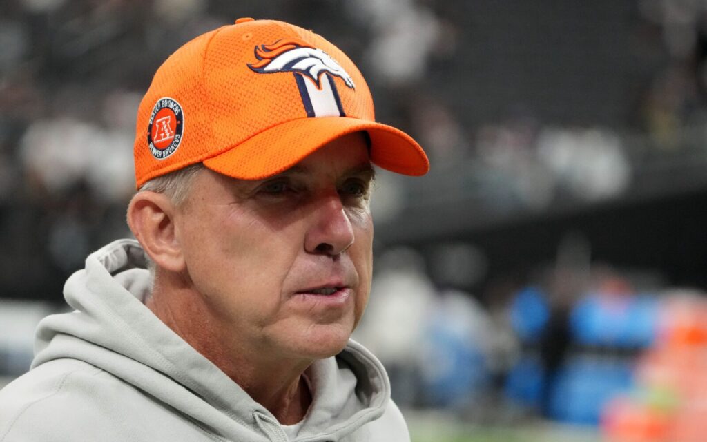 Sean Payton with an orange Broncos hat on.