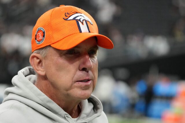 Sean Payton with an orange Broncos hat on.