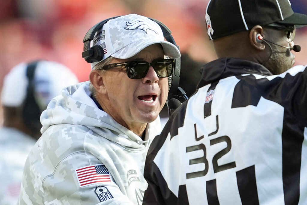 Denver Broncos head coach Sean Payton talks to line judge Jeff Bergman during the second half against the Kansas City Chiefs at GEHA Field at Arrowhead Stadium.