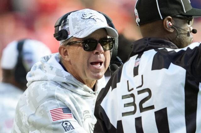 Denver Broncos head coach Sean Payton talks to line judge Jeff Bergman during the second half against the Kansas City Chiefs at GEHA Field at Arrowhead Stadium.