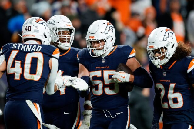 Cody Barton and Broncos teammates celebrate.