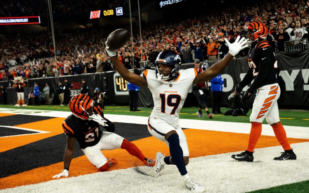 Marvin Mims celebrates while two Cincinnati Bengals players can’t believe his catch.