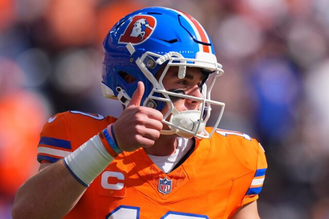 Bo Nix with the throwback Denver Broncos uniform on has a thumbs up.