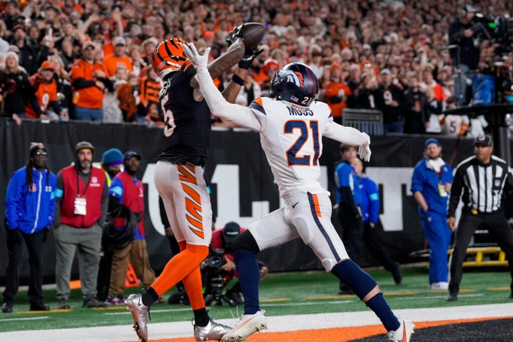 Cincinnati Bengals wide receiver Tee Higgins (5) catches a touchdown pass over Denver Broncos cornerback Riley Moss (21) in the fourth quarter of the NFL Week 17 game between the Cincinnati Bengals and the Denver Broncos at Paycor Stadium in downtown Cincinnati on Saturday, Dec. 28, 2024.