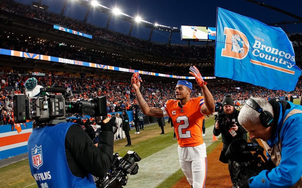 Pat Surtain celebrates a Broncos win with videographers following him.