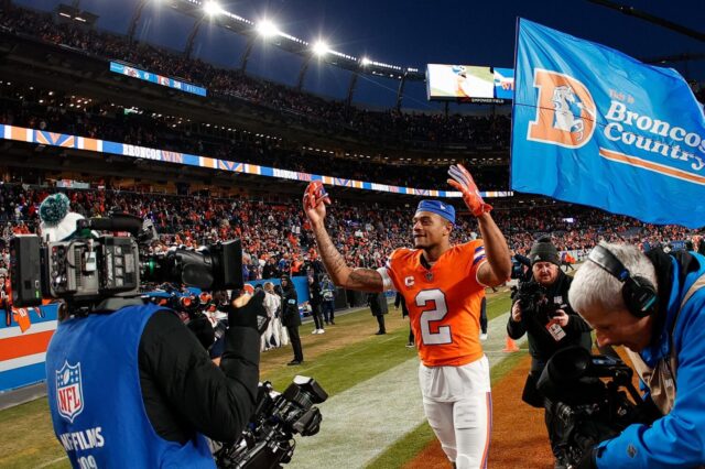 Pat Surtain celebrates a Broncos win with videographers following him.