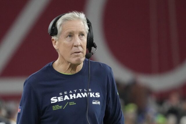 Pete Carroll in a Seahawks shirt on the sideline.