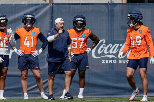 Drew Sanders (41) with Dre Greenlaw (57) and Alex Singleton (49) at training camp practice on July 24.