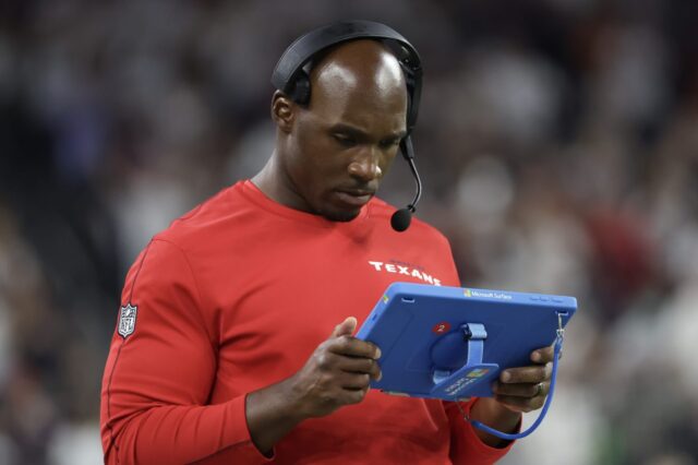 DeMeco Ryans, Texans Head Coach, uses a Microsoft tablet on the sideline of a game in 2024.