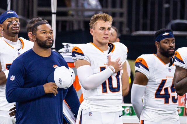 Bo Nix and teammates put their hands over their heart for the National Anthem.